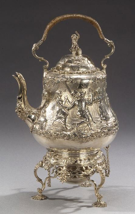 A VICTORIAN STERLING TEAPOT WITH BURNER O: A VICTORIAN STERLING TEAPOT WITH BURNER ON STAND, London, 1879-80, maker's mark of George Fox. The teapot of bombe form, repousse with villagers dancing and making merry, a churchyard and houses in th