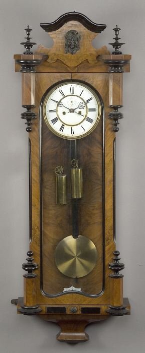 A LENZKIRCH DOUBLE WEIGHT VIENNA REGULATO: A LENZKIRCH DOUBLE WEIGHT VIENNA REGULATOR WALNUT AND EBONIZED WALL CLOCK, late 19th century. The case with molded serpentine crest centering an ebony female mask flanked by urn finials above the arch