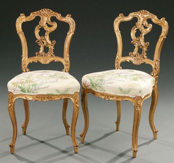 A SET OF FOUR LOUIS XV STYLE GILTWOOD CHAISES, lat: A SET OF FOUR LOUIS XV STYLE GILTWOOD CHAISES, late 19th/early 20th century. With shell cresting above the rocaille-pierced splat and upholstered seat, on foliate-carved cabriole legs