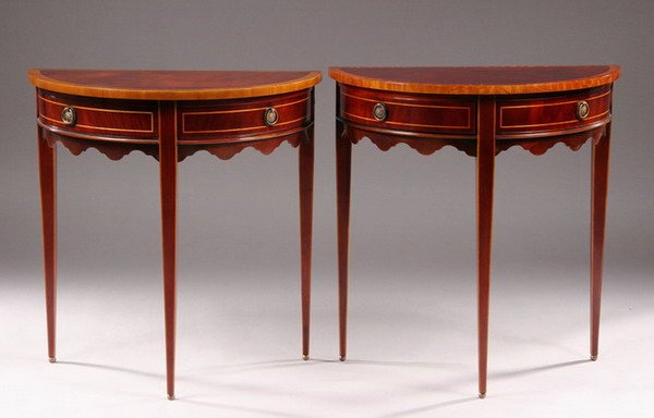 PAIR GEORGE III STYLE INLAID MAHOGANY DEMI-LUNE C: PAIR GEORGE III STYLE INLAID MAHOGANY DEMI-LUNE CONSOLE TABLES, 20th century. Tops have satinwood and banded edge; double paneled frieze; boxwood stringing; hinged, out-swinging drawers; shaped apron;