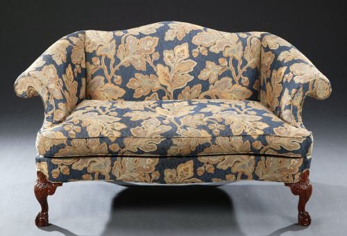 TWO CHIPPENDALE STYLE UPHOLSTERED SMALL SETTEES, 2: TWO CHIPPENDALE STYLE UPHOLSTERED SMALL SETTEES, 20th century. Each with serpentine crest, outscrolling arms, serpentine seat with single squab cushion, on foliate-carved cabriole legs ending in claw