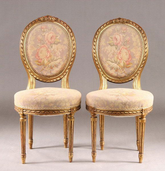 PAIR LOUIS XVI STYLE GILT-WOOD CHAISES, late 19th-: PAIR LOUIS XVI STYLE GILT-WOOD CHAISES, late 19th-early 20th century. Foliate-carved crest above ribbon-twist oval medallion backs, with padded inserts circular seats; turned tapering fluted legs. - 3