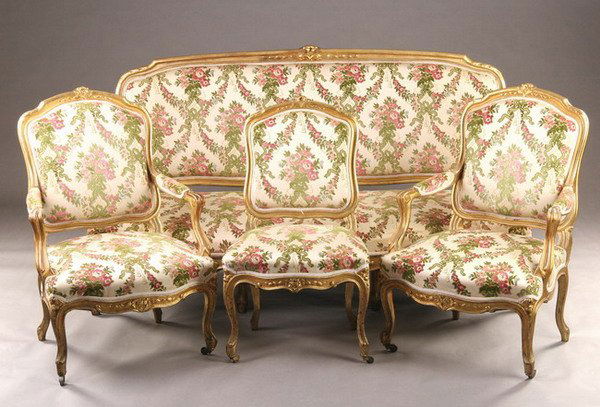 SEVEN-PIECE LOUIS XV-STYLE GILT-WOOD UPHOLSTERED: SEVEN-PIECE LOUIS XV-STYLE GILT-WOOD UPHOLSTERED SALON SUITE, late 19th - early 20th century. Including canap?, pair of chaises, and four fauteuils, with padded cartouche backs, serpentine stuff-over