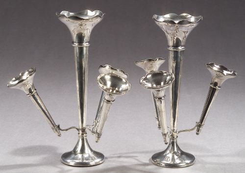 A PAIR OF STERLING EPERGNES, Birmingham, 1914, mark: A PAIR OF STERLING EPERGNES, Birmingham, 1914, marked Made in England for Tiffany & Co.". Central trumpet surrounded by three smaller trumpets, weighted circular bases - 10 in. high."