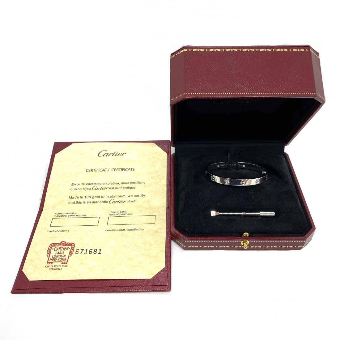 An authentic 18ct white gold 4 diamond Cartier Love: An authentic 18ct white gold 4 diamond Cartier Love bracelet / bangle with original screw, box and Cartier certificate paperwork. Size 15. Signed and numbered Cartier with relevant serial numbers and 