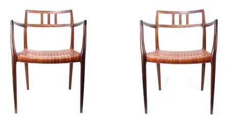 A pair of Danish rosewood carvers (model 64) with origi: A pair of Danish rosewood carvers (model 64) with original brown leather woven cord seats designed by Niels Otto Moller in 1966 and made and labeled during 1966-69 by J L Moller
