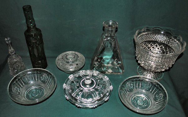Lot of 8: Vintage Cut Crystal Serveware, Bottle, Decant: Lot of 8 vintage cut crystal & handblown glass collection - includes two covered bowls (one irridiscent), 2 open bowls, triangular decanter, green handblown glass bottle, bell, and large footed bowl.