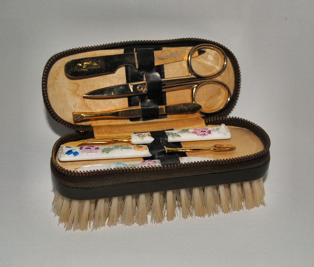 Vintage Vanity Grooming Kit Sheffield England: Vintage brush with leather zippered top in a floral design. Contains manicure and vanity supplies - scissors (marked Made in Sheffield England), floral handled Bakelite-type manicure tools, tweezers,