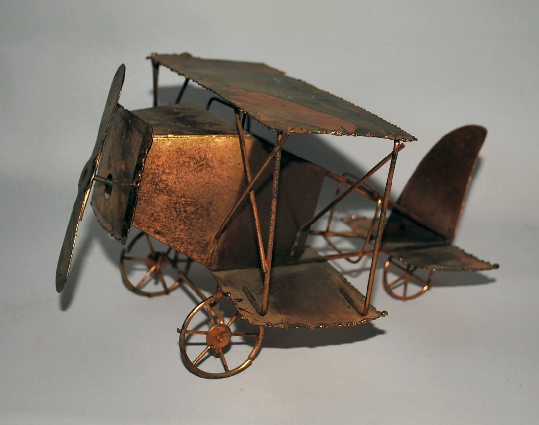 Copper Biplane Music Box: Rustic copper crafted biplane with hidden music box behind nose. Propellor winds the music box; plays "Fly Me to the Moon." 9"l x 8"w x 5"h.