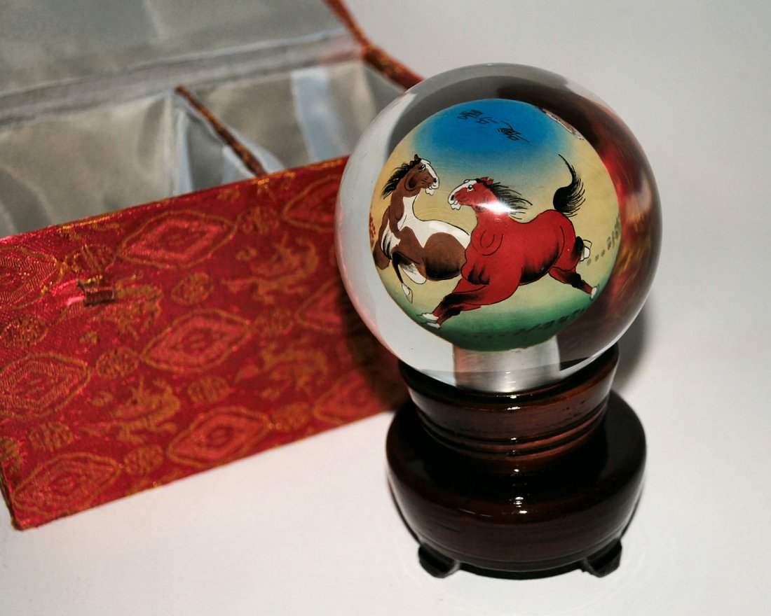 Handpainted Chinese Crystal Art Glass: Handpainted Chinese crystal sphere. The balls are painted through a small hole on the bottom of the crystal and each is unique. Laquered wood stand and fabric covered box. Crystal is 3" diamter.