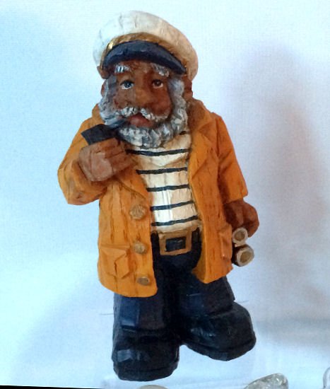 Wood Sailor Figurine: Traditional carved wood old sailor figurine with beard, yellow coat & pipe. Made in China. 8"h