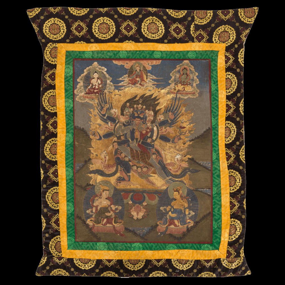 Tibetan Thangka: Tibetan Buddhist Thangka, hand-painted canvas sewn into silk tapestry with painted blessing on reverse. Thangka features a centered wrathful deity with many faceds surrounded by 5 others; tapestry is 