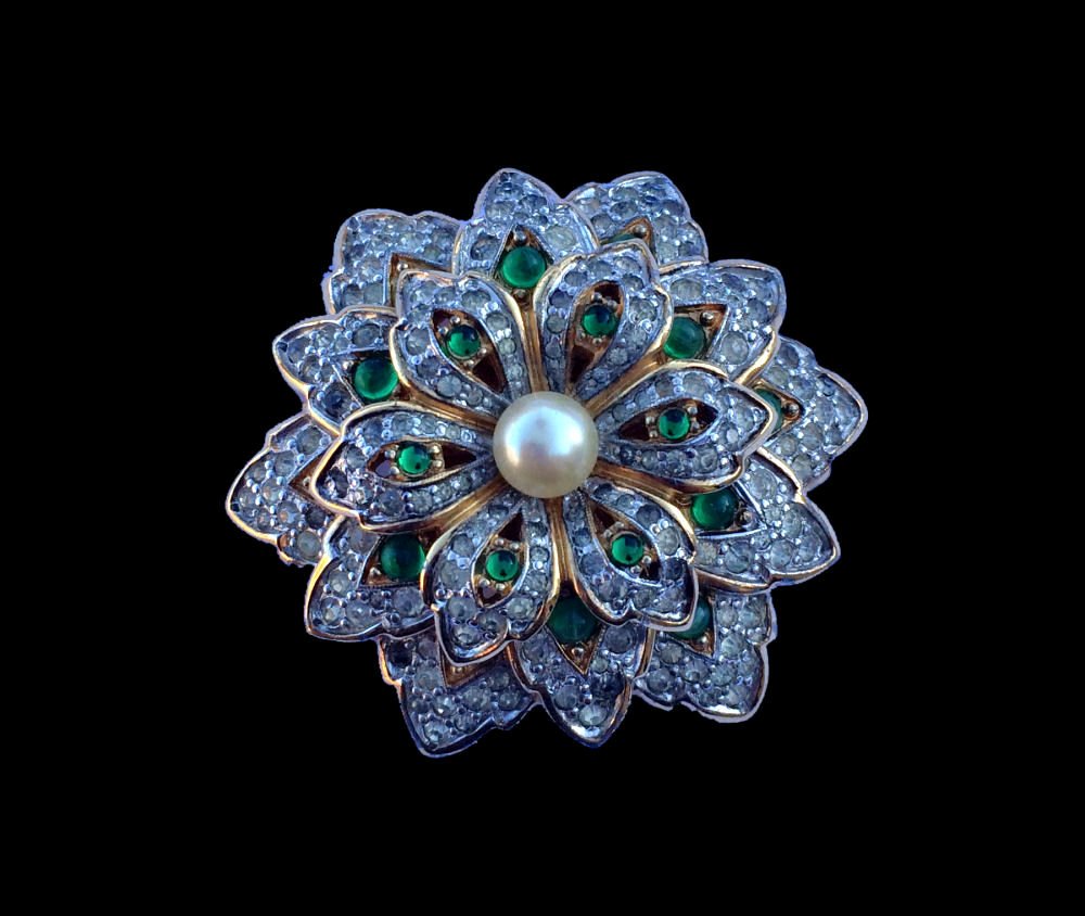 Jomaz Layered Rhinestone Brooch: Beautiful Jomaz layered flower vintage brooch pin with pearl center. Gold tone base with clustered white and green rhinestones. 1-7/8"d.