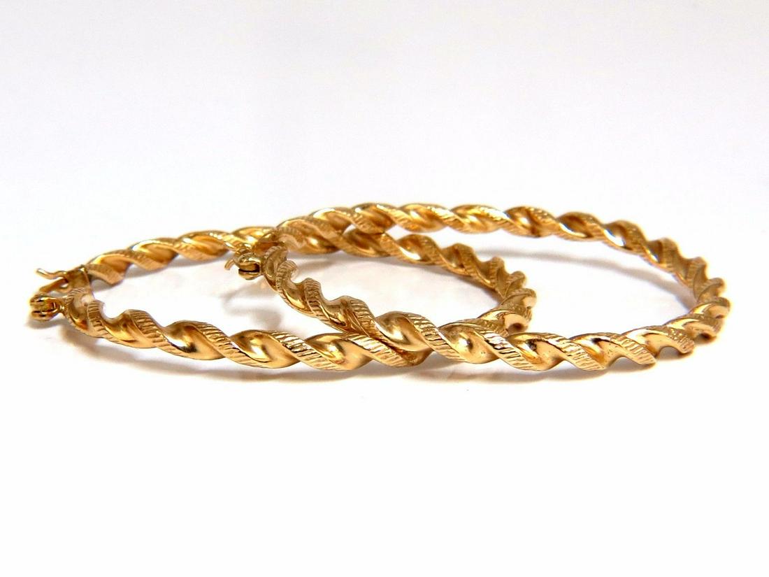 14kt 1.75 inch gold hoop earrings twist lightweight: Hollowed Hoop Twister3d textured EarringsMeasurements of Earrings:1.75 inch3 grams / 14kt. yellow gold / Very LightweightComfortable lever closure