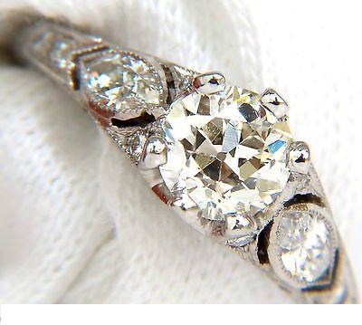 PLATINUM 1.90CT EUROPEAN OLD CUT DIAMOND RING SCALING: .90ct. Old Miner Round Diamond 6.3mm diameter J-color, Si-1 clarity. 1.00ct. side diamonds H-color, Vs-2 si-1 clarity. Platinum 3.9gms. Ring has gorgeous etching detail on profile. Gorgeous antique pa