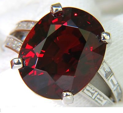 23.39CT NATURAL SPESSARTITE GARNET DIAMOND RING G/VS: 21.69ct. Natural Spessartite Amazing oval cut VS Very Very Clean Clarity Beautiful Red sparkles throughout Transparency A+ 17.3 X 13.9mm Side diamonds: 1.70ct. Brilliant sparkling baguette cuts Full c