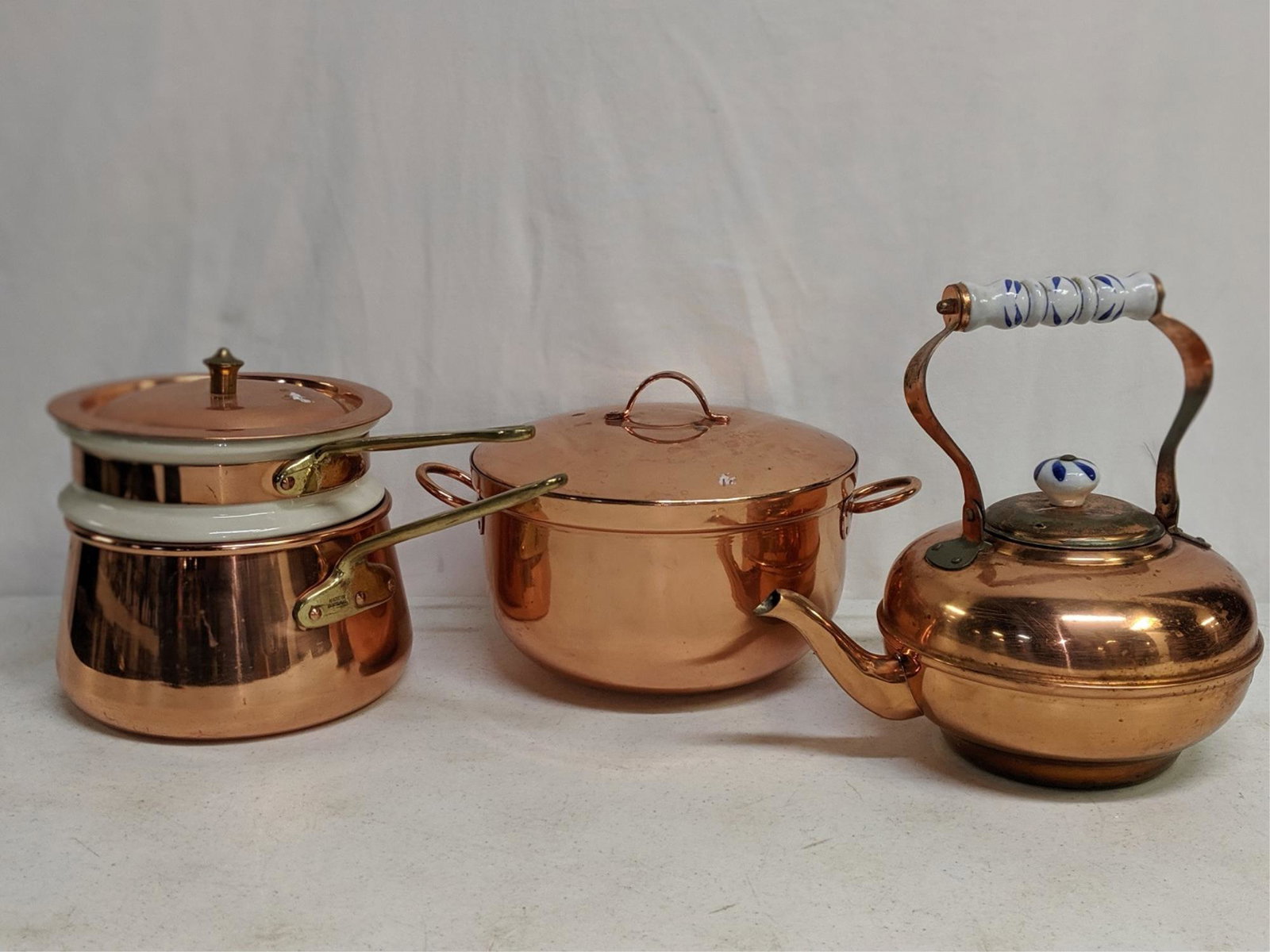 3 pieces of copper cookware: 3 pieces of copper cookware Double boiler that is 6 1/2" T , cover pot that is 9 " in diameter, and a Teapot that is 5" T