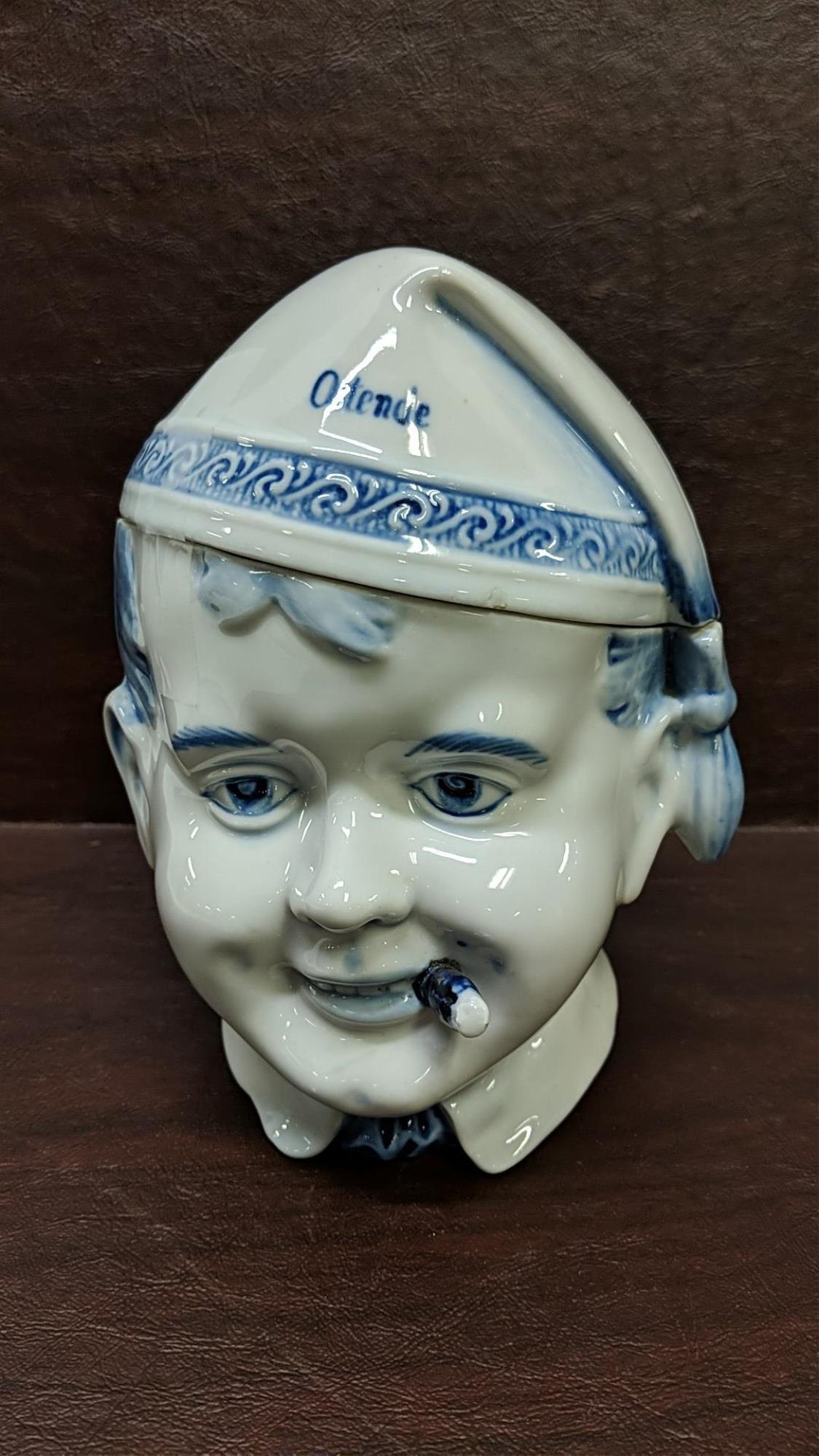 Belgium Tobacco Jar: Small chip on edge of smokers hat 6 3/4" T