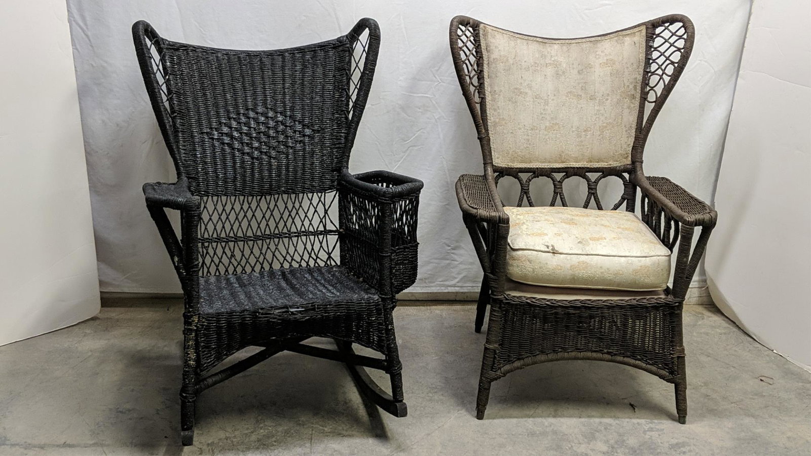 Antique Wing Back wicker rocker and chair: rocker is black and has a magazine holder arm, the chair has a cushion and the back is upholstered. rocker is 29" W x 32" D x 42" T and the chair is 29" W x 24" d x 42" T