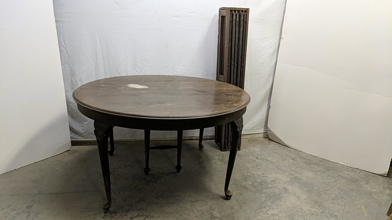Antique Queen Anne dining table: includes five 9" wide leaves Needs refinishing without leaves measures 54" diameter and 30" T