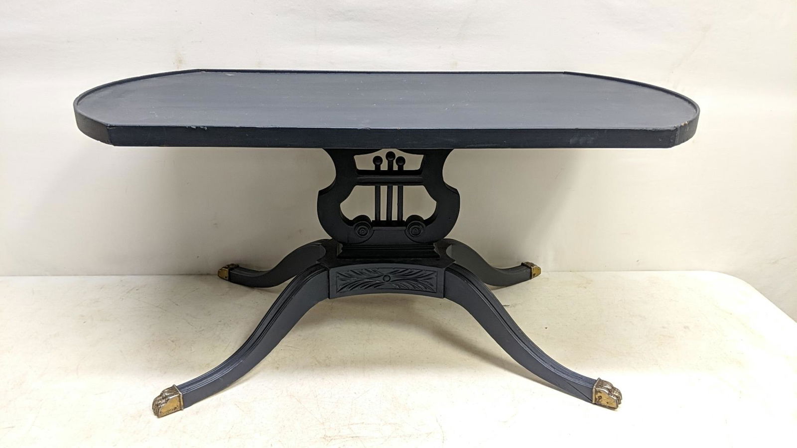 Oval Duncan Phyfe painted coffee table: painted royal blue with brass claw foot caps on feet