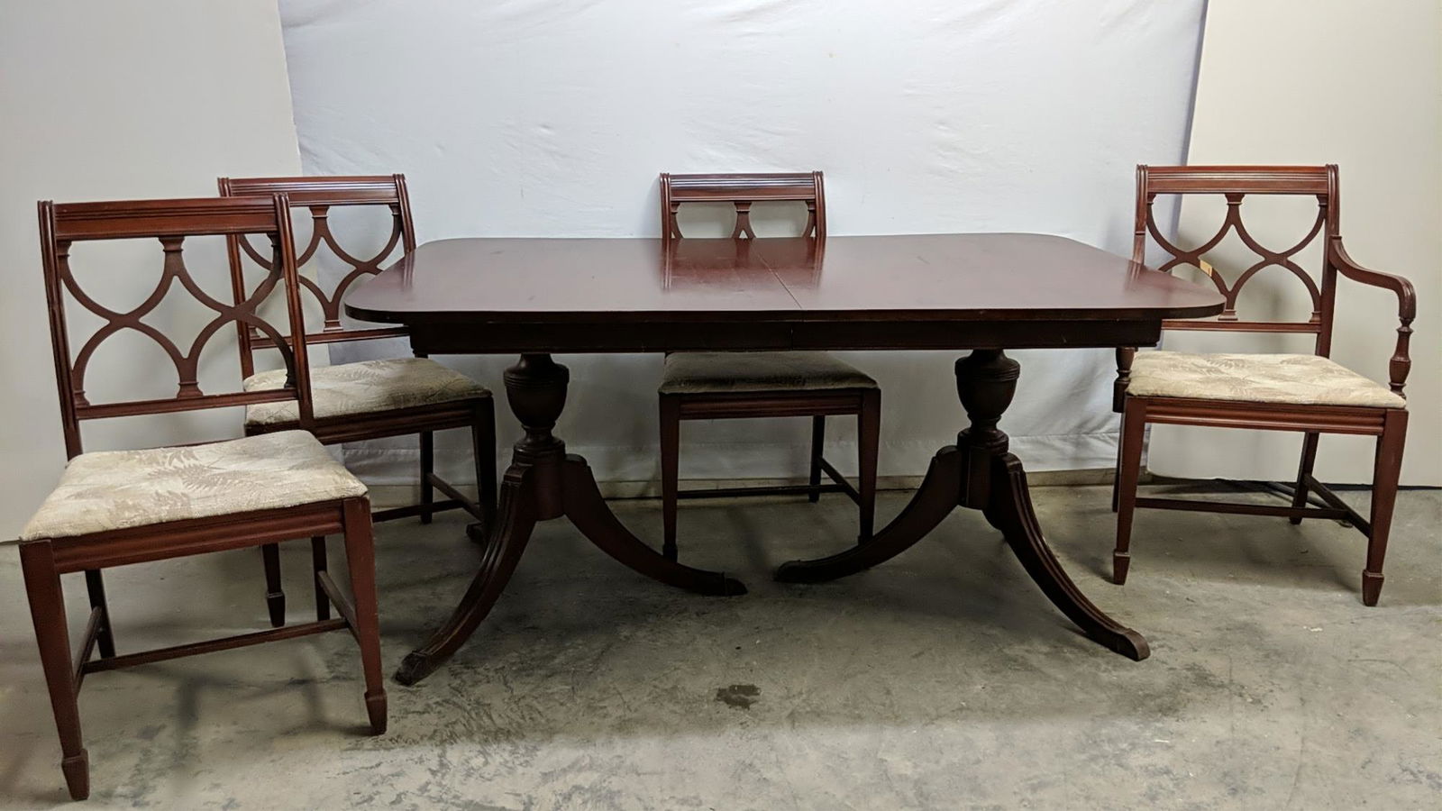 Mahogany Duncan Phyfe table & 4 chairs: 3 side chairs and 1 arm chair as is crack in 1 pedestal includes 1 leaf