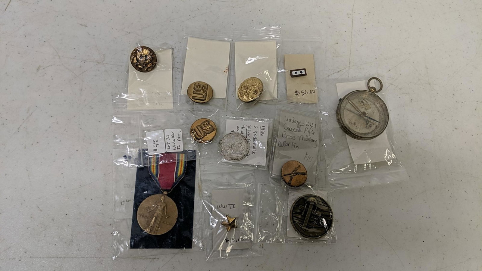 11 pieces of military pins etc.: Sterling mother pin, 1936 WWII 5 mark 900 silver coin, compass, metals and pins