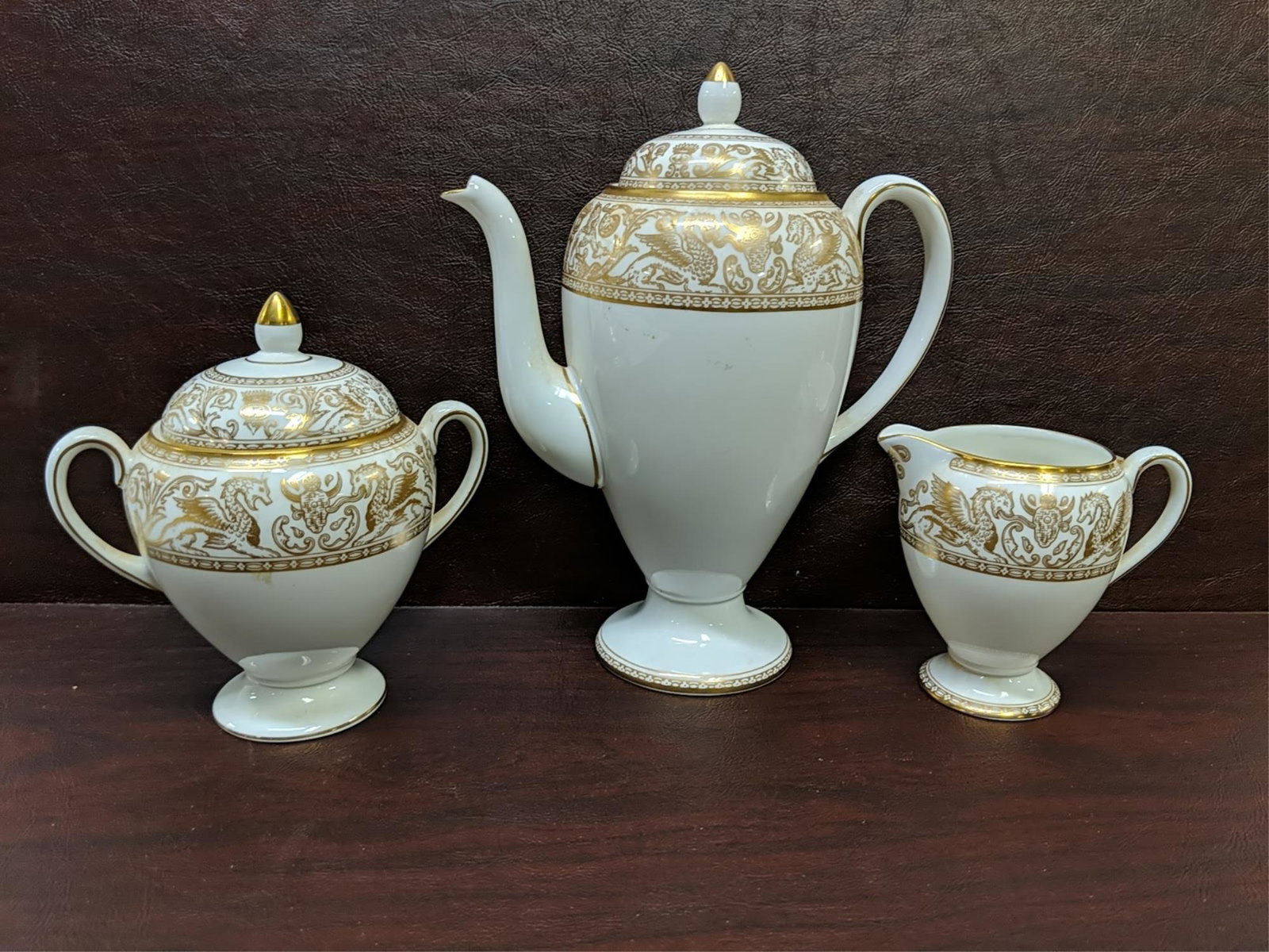 3 pcs. Wedgewood Florentine Dragons on white: pot is 8 3/4" T, creamer is 4" T and sugar is 5 1/2" T