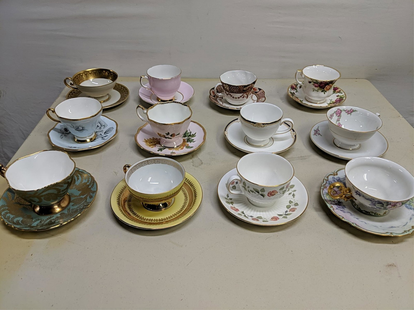 12 assorted styles and patterns cups and saucers: English and Bavarian
