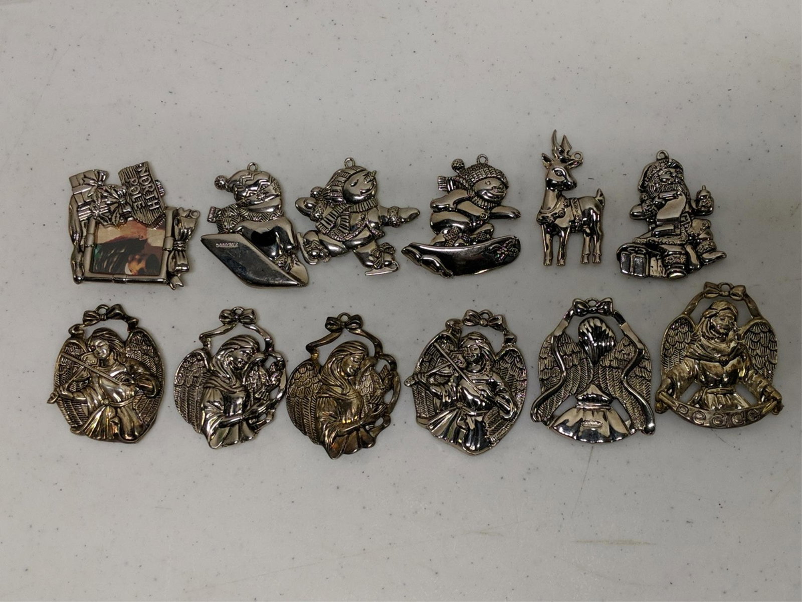 12 Gorham silverplate Christmas ornaments: various sizes and styles, some angels, gifts and toys all are about 3" T