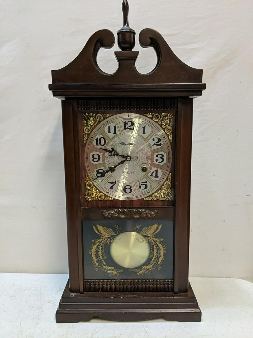 Champion 31 day clock: has pendelum and key and running 26" t x 12 " W x 5" D