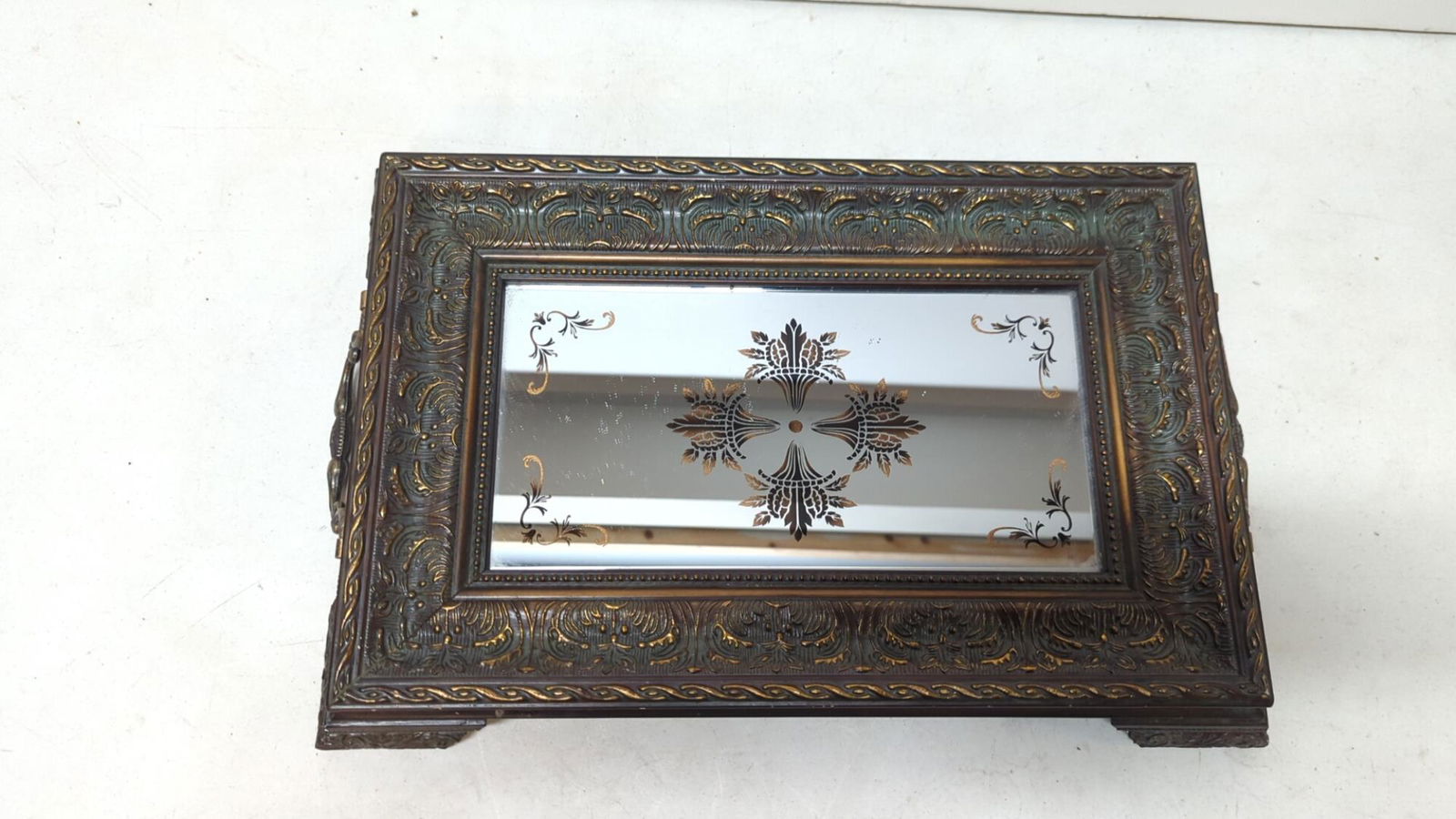 Ornate tray with reversed painted mirror: ornate metal handles carved edges and feet great condition
