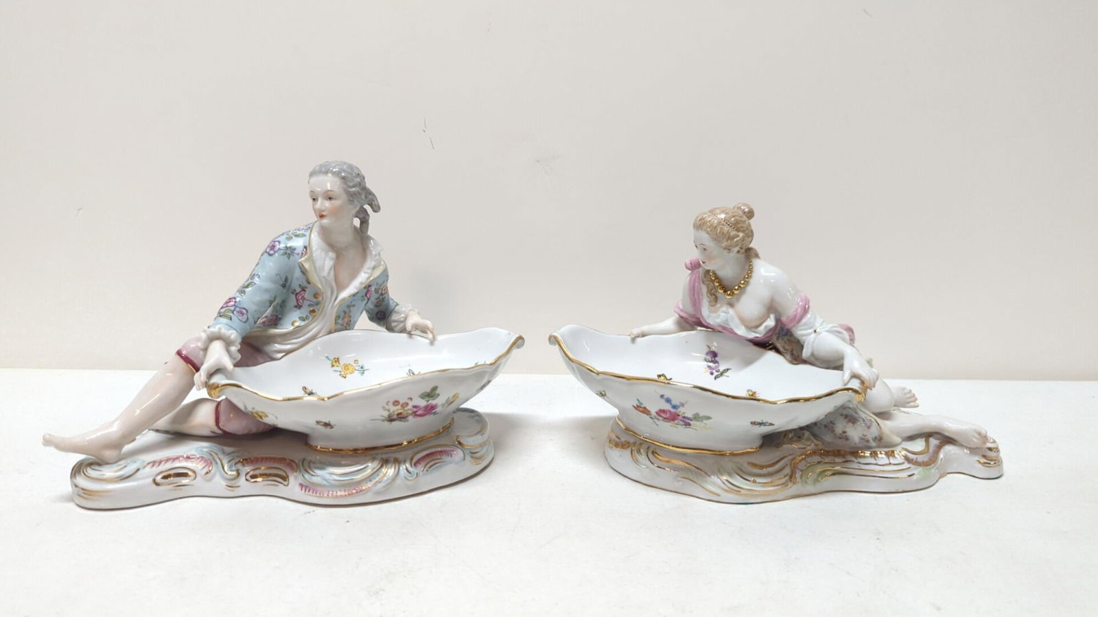 pair Meisen Porcelain Sweet Meat dishes: good condition NO breaks or chips Crossed sword mark Man & Woman reclining next to oval bowls with floral & butterfly decoration 11" l x 7 " W approximately
