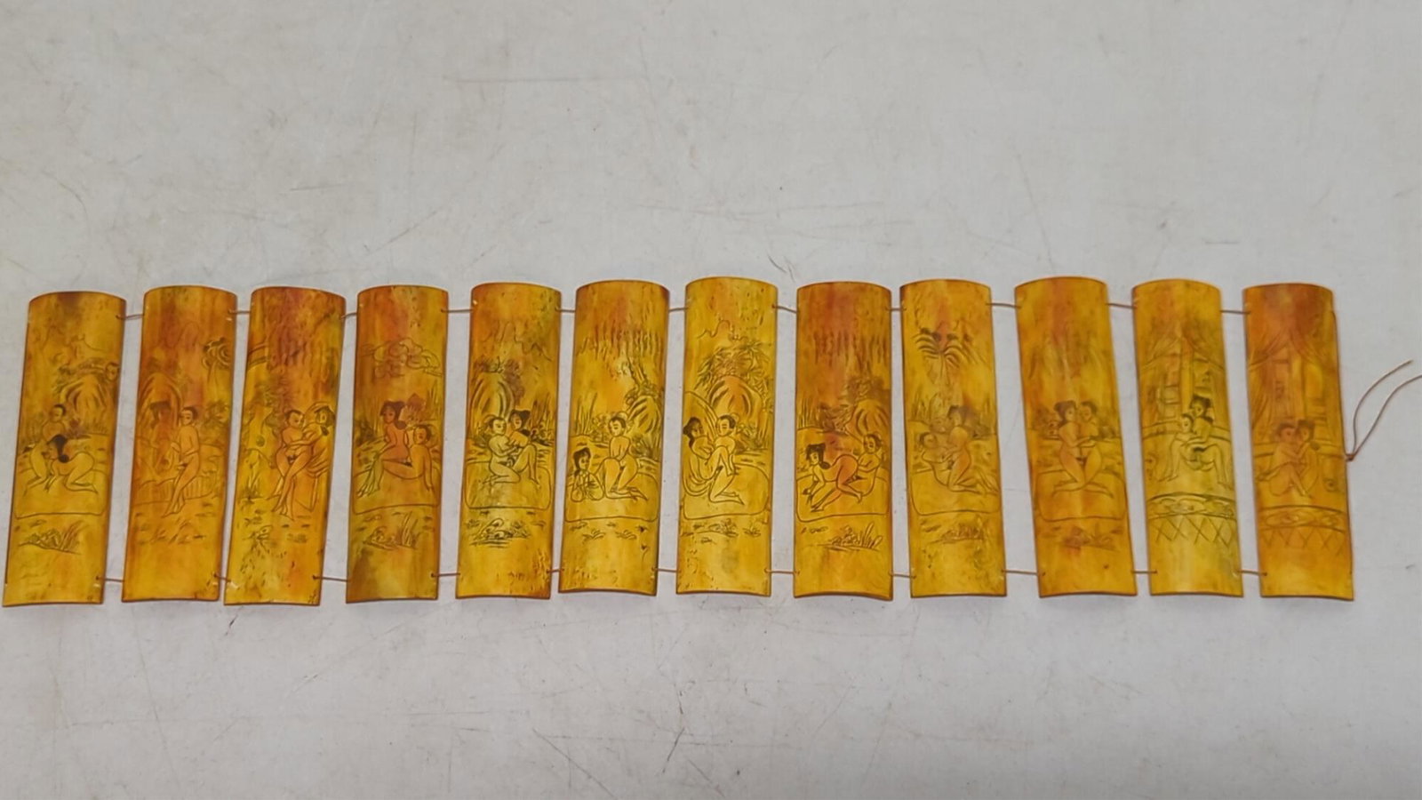 Japanese Scrimshaw Erotic bone panels: Set of 12 Japanese, Scrimshaw bone panels with erotic scenes. Drilled holes and strung together as a set. Circa late 19th early 20th Ct. Each panel is 5 1/2" T x 1 7/8" W. All in good condition