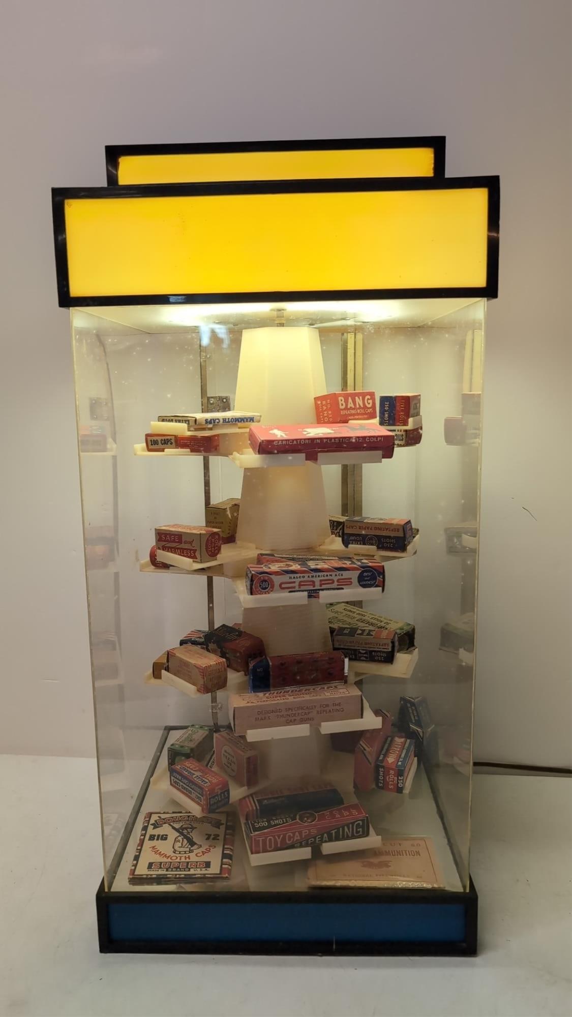 Vintage Plastic revolving display cabinet w/caps: 42 boxes of cap gun caps lights up 24" t x 11 3/4" square includes key
