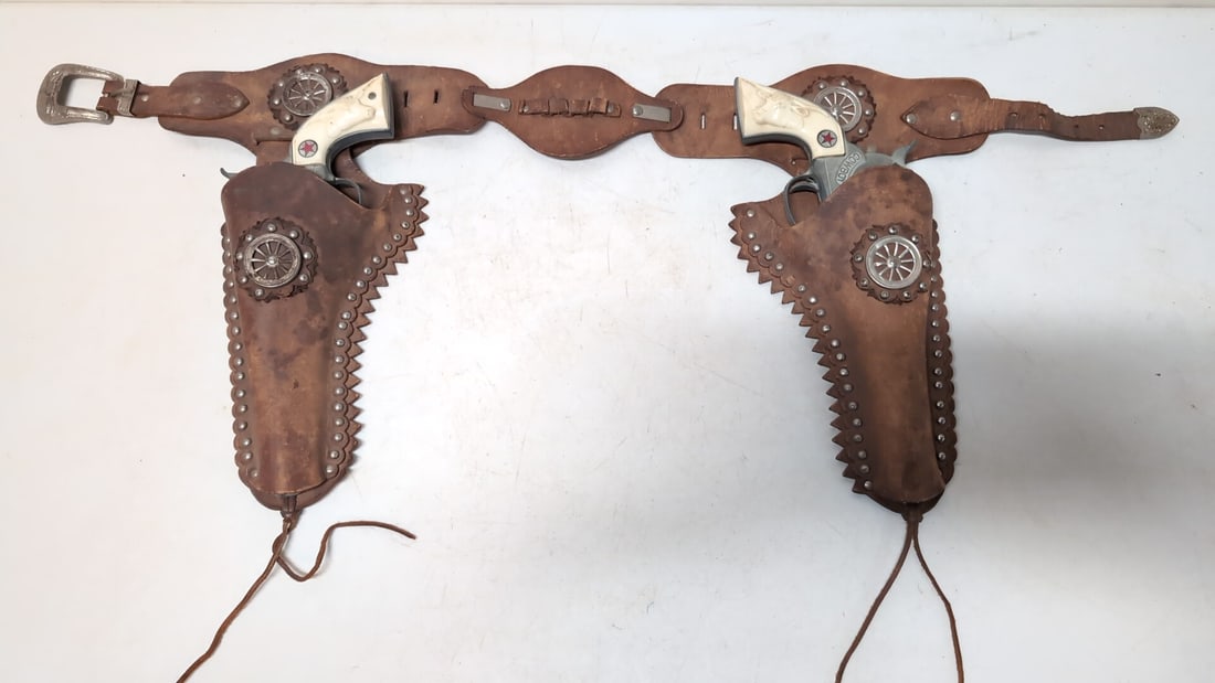 Pr. Cowboy Cap guns in Leather Holster: guns work and are in good condition Holster is also in good used condition