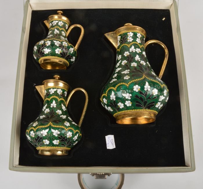 A graduated set of three Soviet Russian silver col: A graduated set of three Soviet Russian silver coloured gilt and enamel baluster jugs and covers, post 1958 .916 standard, circa 1975, with floral decoration on a green ground, 20.5cm (8in),