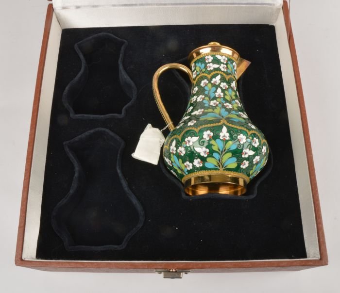 A Soviet Russian silver coloured gilt and enamel b: A Soviet Russian silver coloured gilt and enamel baluster jug and cover, post 1958 .916 standard, circa 1976, with floral decoration on a green ground, 20.5cm high, 23.4 oz gross, in a case f