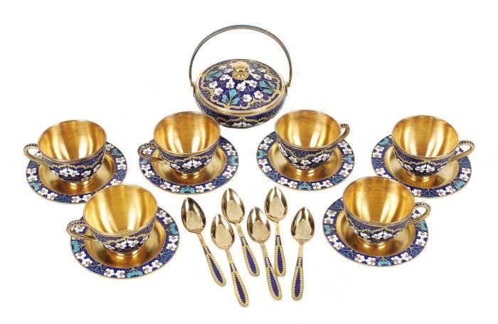 A Soviet Russian silver coloured gilt and enamel c: A Soviet Russian silver coloured gilt and enamel coffee service, post 1958 .916 standard, circa 1976, with floral decoration on a blue ground, comprising six of coffee cups, saucers and spoon