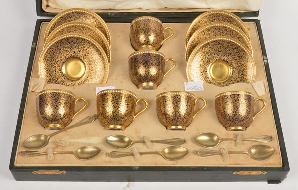 A Royal Worcester coffee set for six settings, pai: A Royal Worcester coffee set for six settings, painted with foliate sprays on a blue background, with six silver gilt coffee spoons by Henry James Hulbert, London 1925, 10.5cm long, 2.35 oz, all in a 
