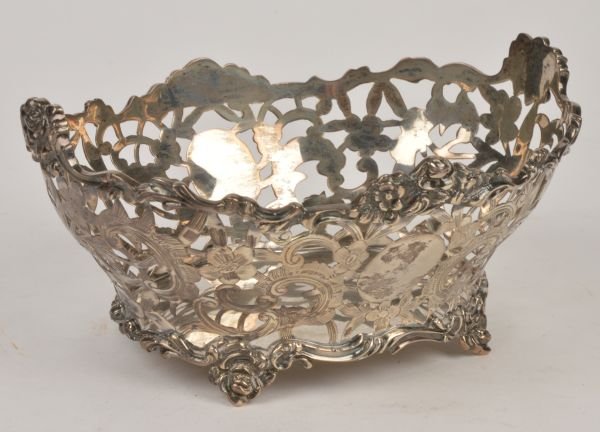 A Victorian silver pierced oval bon bon dish by Ch: A Victorian silver pierced oval bon bon dish by Charles Stuart Harris, London 1899, with a shaped foliate border, the sides pierced with foliate sprays, vacant reserves and on four foliate feet, 15.5c