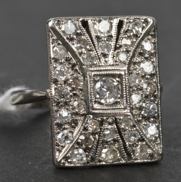 A diamond plaque ring, of rectangular design box c: A diamond plaque ring, of rectangular design box collet set with an old-cut diamond to the centre within a radiating surround of single-cut diamonds, mount stamped '585', ring size M, weight 3.5g gros