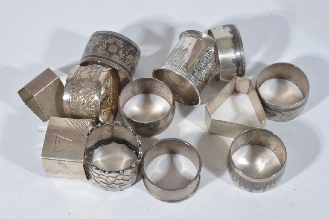 A Russian niello napkin ring of slight concave sha: A Russian niello napkin ring of slight concave shape, decorated with a panel depicting buildings within scrollwork, the oval cartouche initialled GFM, date mark for circa 1869, two similar silver tria