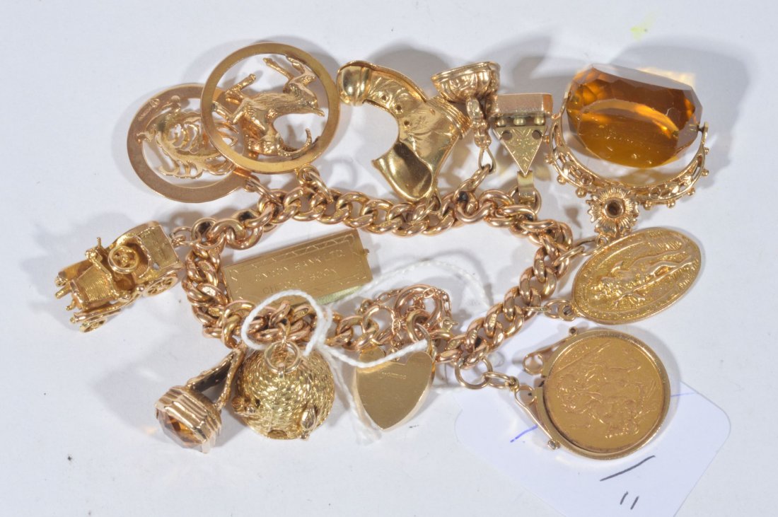 A 9 carat gold charm bracelet, the curb link brace: A 9 carat gold charm bracelet, the curb link bracelet with a 9 carat gold padlock clasp, with various 9 carat gold charms, including a: beehive, a boot, a motor vehicle, a seal, a sovereign 1888, and
