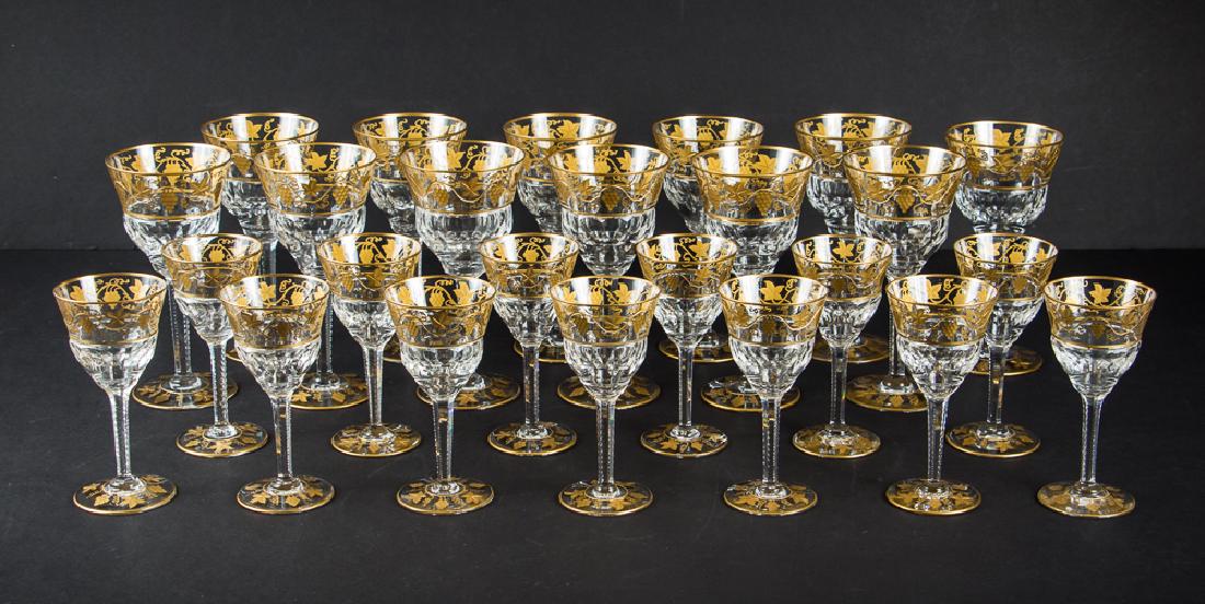 Twenty Six Val St Lambert Gold Encrusted Stemware: Twenty six pieces of Val St. Lambert etched and gold encrusted stemware, composed of 13 wine glasses and 13 cordial glasses. Wine glasses measuring 7 5/8 inches and cordial measuring 5 7/8 inches.