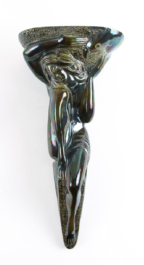 Mid Century Pottery Wall Bracket: Mid century wall bracket, nude woman with parrot, incised with initials W.L. VII, measuring 19 by 8 by 6 inches.