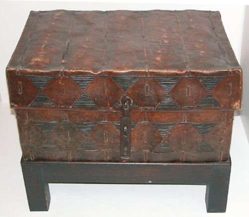 Southwestern American Trunk with later base: Artist: Southwestern American Title: Southwestern American Trunk with hand-wrought iron latch, later base Date: c. 19th century Medium: leather with iron latch and later wood base Dimensions: 13.2 x 2