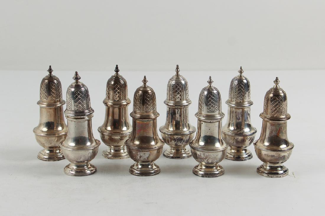 Eight Antique English Sterling Silver Pepper Shakers: Eight matching English sterling silver pepper shakers, by William Harrison Walter, measuring 4.5 inches each and having a total weight of approximately 28 troy ounces.