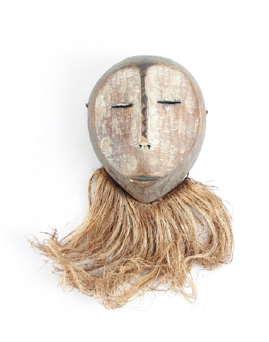 Lega Peoples, Bwami Association mid 20th Century: Legea People, Bwami Association, mid 20th Century, Carved and polychromed wood, pigment & fiber, 16 inches tall (including Raffia beard). Provenance: De-accession from The Boca Raton Museum of Art.