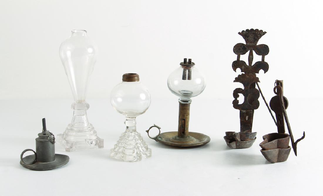 Whale Oil, Betty and Other Antique Lamps: Six antique lighting devices comprised of three whale oil lamps, two Betty lamps, and a Capen and Molineaux pewter sparking lamp, tallest 9.5 inches.